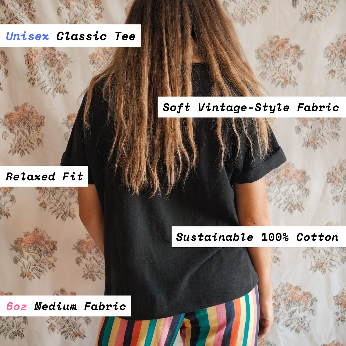 Person wearing a black unisex classic tee with text describing fabric and fit details on a floral background
